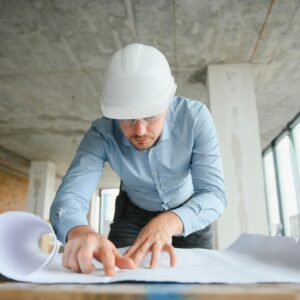 Architect in hard hat with draft